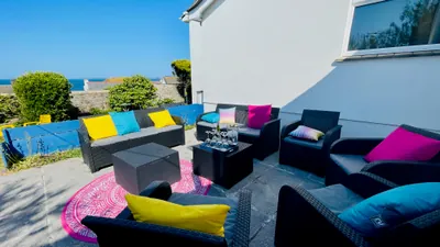 Outdoor seating and sea views at Sunset Beach House